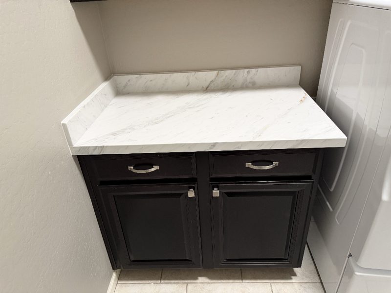 Quartz vanity top on dark bathroom cabinet
